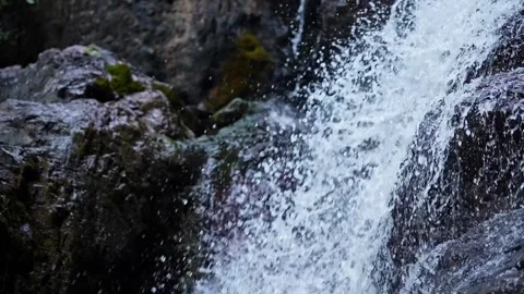 Top-down close-up of fresh mountain water cascading off a rocky cliff in Ka.. Stock Footage 313381143