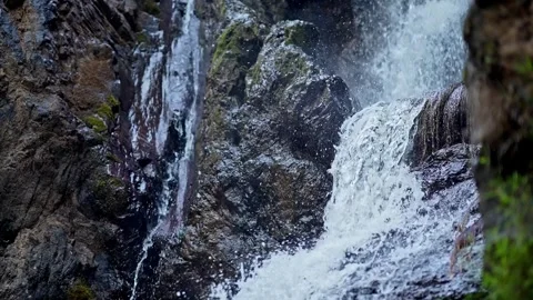 Top-down close-up of fresh mountain water cascading off a rocky cliff in Ka.. Stock Footage 313381145