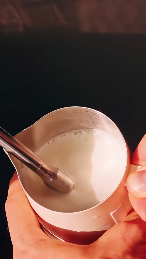 Top Down Close Up Of Hands Frothing Milk In Pitcher With Steam Wand Creating Mic Stock Footage 331365662