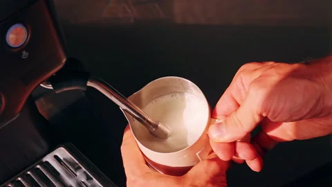Top Down Close Up Of Hands Frothing Milk In Pitcher With Steam Wand Creating Mic Stock Footage 331415890