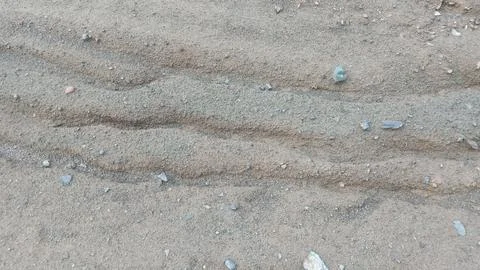 Top Down Close Up of Sand Waves and Water Erosion Pattern on Dirt Ground Stock Photos