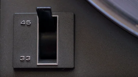 Top down close up shot of flipping spinning turntable rpm switch Stock Footage 88763272