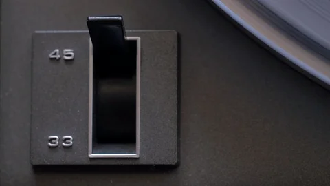 Top down close up shot of flipping spinning turntable rpm switch Stock Footage 88763339