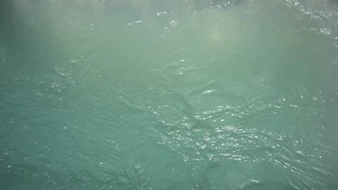 Top-Down Close-Up of Swirling Turquoise Water Surface in a Deep Basin Stock Footage 334623400
