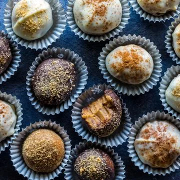 A top down close up view of pumpkin spice truffles with a bite out of one. Stock Photos