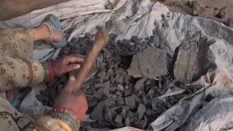 Top-Down Close-Up of Worker Breaking Rock Fragments with Hammer by Hand Stock Footage 347687132