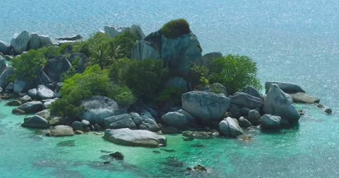 Top Down Coastal Water Pattern with Granite Rock Formation Indonesia 库存影片 329773080