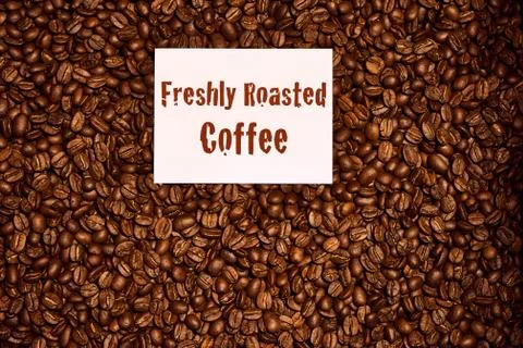 Top Down of coffee beans with freshly roasted coffee sign Stock Photos