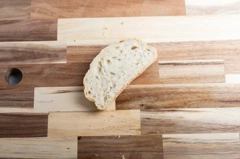 Top-down composition of bread loaf on rustic board  rustic food scene Stock Photos