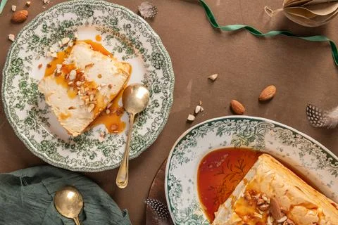 A top-down composition features slices and a whole traditional caramelized .. Stock Photos