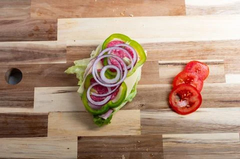 Top-down composition of red onion slices on cutting board  food preparation.. Stock Photos