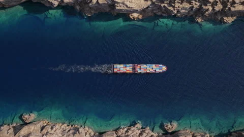 Top down container ship crossing narrow rocky coastal strait Stock Footage 340332264