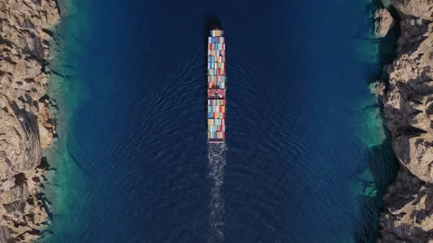 Top down container ship navigating narrow rocky coastal strait Stock Footage 340332257