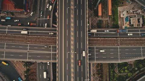 Top down cross traffic highway with cars, trucks aerial. Urban transportation at Stock Photos