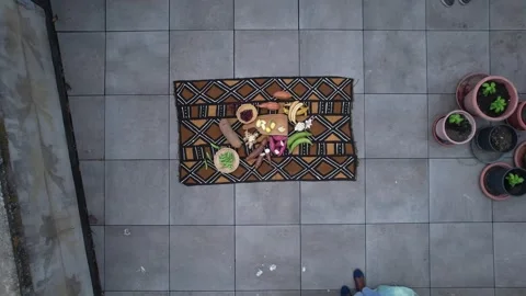 Top down descent over African textile with fresh tropical vegetable and fruit Stock Footage 331035314