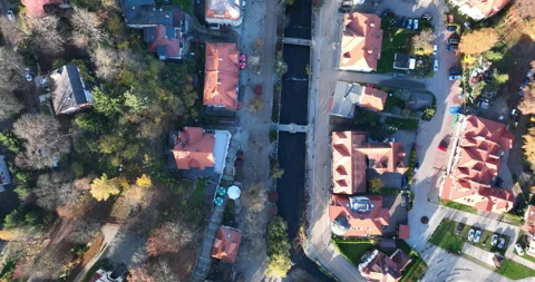 Top down descent over Polanica-Zdrój spa town and river in autumn Stock Footage 346613888