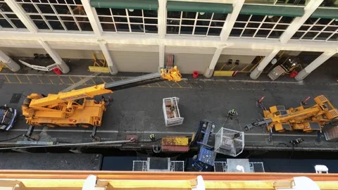 Top down-Dock crew load supplies on a cruise ship with cranes and fork lifts Stock Footage 210343006