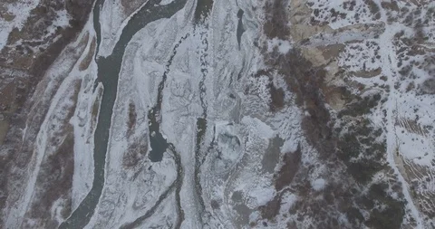 Top down. Drone Aerial Flight in the mountains in winter. Mountain road Stock Footage 94662354