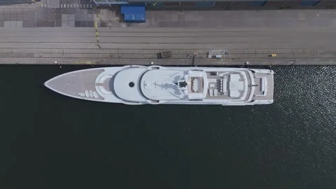 Top down drone aerial of luxury yacht moored at harbor Video stock 335995742