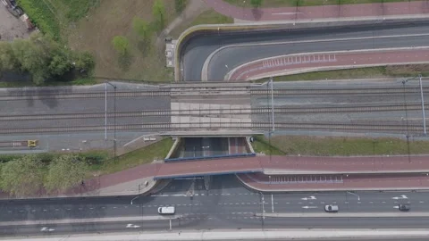 Top down drone aerial of railway crossing above road and bicycle path Video stock 335996147