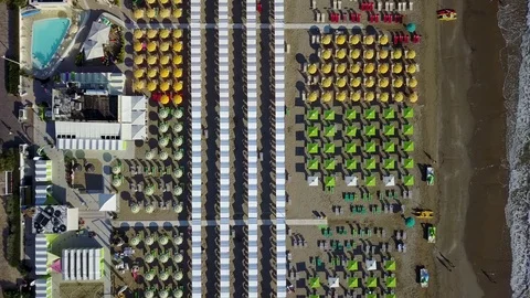 Top down drone aerial view of the umbrellas and gazebos on Italian sandy beaches Stock Footage 84466204