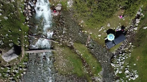 Top Down Drone Approach To Riverside Camp. Kyrgyzstan, Suttuu-Bulak Lake. Stock Footage 332787382