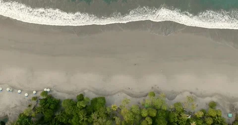 Top down drone ascent above tropical Pacific beach and breaking waves in Costa Stock Footage 340543481
