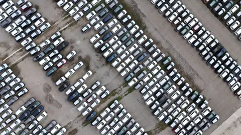 Top down drone ascent above massive vehicle storage lot with hundreds of new Stock Footage 340603987