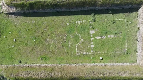 Top-down drone ascent over 18th-century pig farming structure Stock Footage 308900541