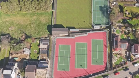 Top down drone ascent over Stocksbridge Tennis Club ITF standard hard courts Stock Footage 334164323