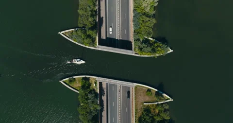 Top-Down Drone of Boat-Shaped Aqueduct of Veluwemeer with Boat Above and Cars Stock Footage 342345991