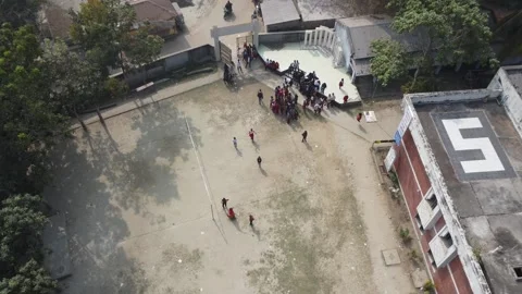 Top Down Drone Descent Over Schoolyard with Children and Bangladesh Flag Stock Footage 327642385