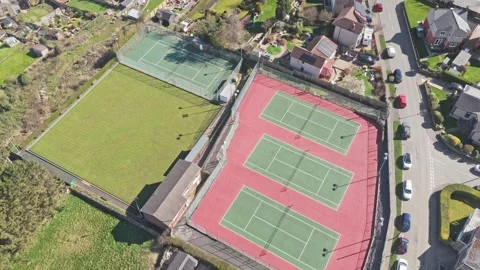 Top down drone descent over Stocksbridge Tennis Club three hard courts layout Stock Footage 334164321
