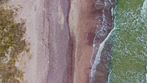 Top Down Drone Flight Above Nida Pebble Beach and Baltic Sea Wave Patterns Stock Footage 337930371