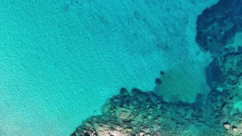 Top-Down Drone Flight Highlighting Turquoise Water Dominance in La Marmo Vídeo Stock 332787517