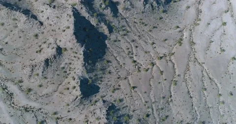 Top down drone flight over rugged rocky terrain in eroded gully plane aerial Video stock 147238065