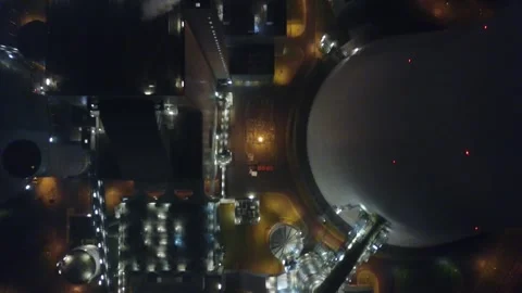Top down drone flight over illuminated industrial plant complex Stock Footage 331885225