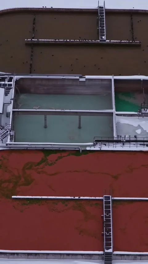 Top Down Drone Flight Over a Snow Covered Industrial Water Treatment Facility Stock Footage 337148399