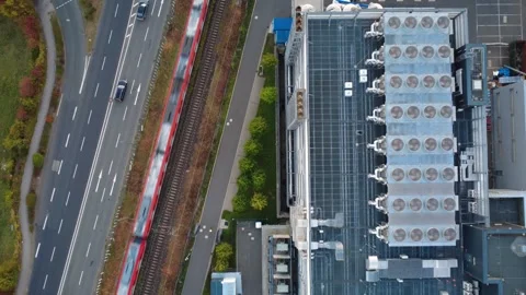Top Down Drone Flight Over Data Center Cooling Fans, Road and Moving Train Stock Footage 346703321