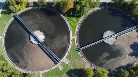 Top Down Drone Flight Over Sewage Clarifier Tanks with Visible Sludge Stock Footage 347713986