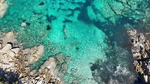 Top-Down Drone Flight Showcasing Turquoise Water Tones in Capo Testa, Sa Stock Footage 332266298
