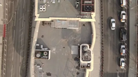 Top down drone flying backward over city rooftop Video stock 333668389