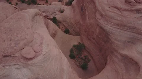 Top down drone flying over smooth red rock face Stock Footage 167657088