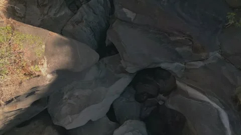 Top down drone flyover above giant quartzite potholes at Vale da Lua Brazil Stock Footage 341658499