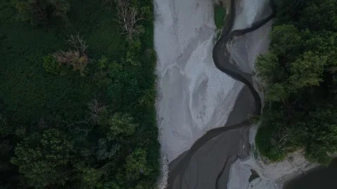 Top-down drone flyover of dry Po River side channel during summer drought Stock Footage 339025740