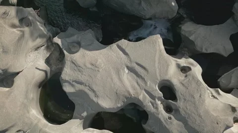 Top down drone flyover of sculpted quartzite potholes at Vale da Lua Brazil Stock Footage 341660562