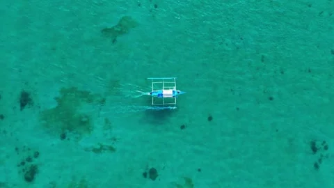 Top Down Drone Follow Of White Blue Bangka Boat In Clear Paradise Water Vídeo Stock 327638198