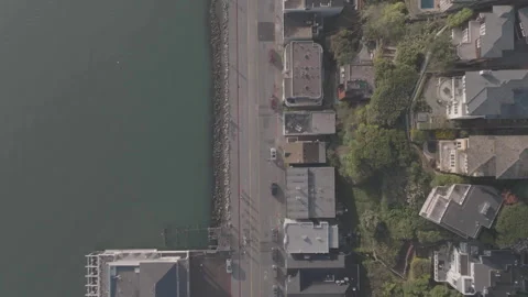 Top-down drone following road centered in frame along riverbank in SF Stock Footage 336793050