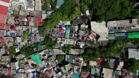 Top-down drone footage of dense coastal neighbourhood near coastal canal. Stock Footage 336926913