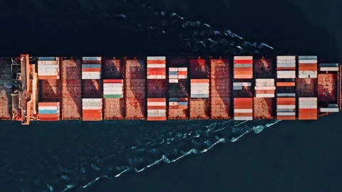Top down drone footage shows a fully loaded cargo vessel navigating the open Stock Footage 341871890